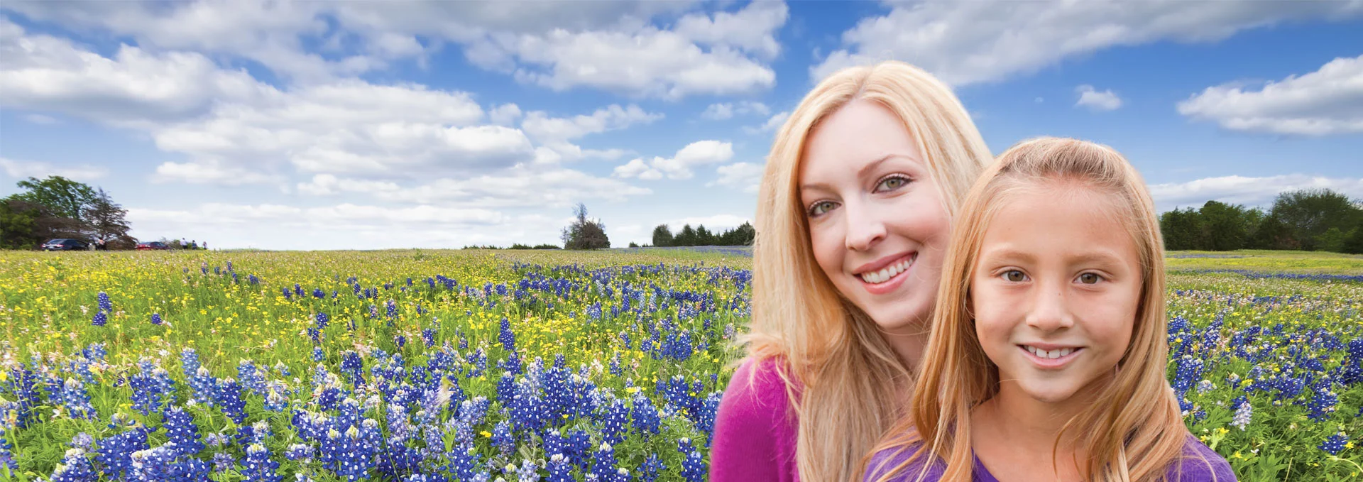 Mother and daughter in a field of flowers.
